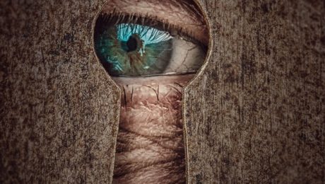 Eye looking through keyhole