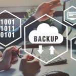 Backup and recovery icons for computer overlaid on people working on computers