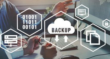 Backup and recovery icons for computer overlaid on people working on computers