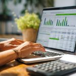 Accountant working on accounting software on laptop