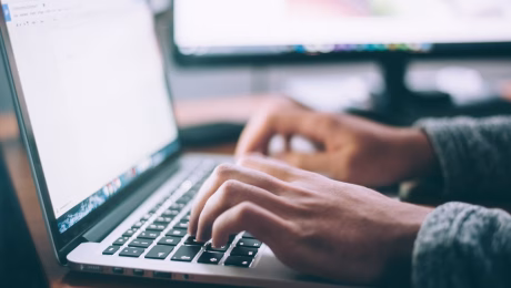 man working on open laptop